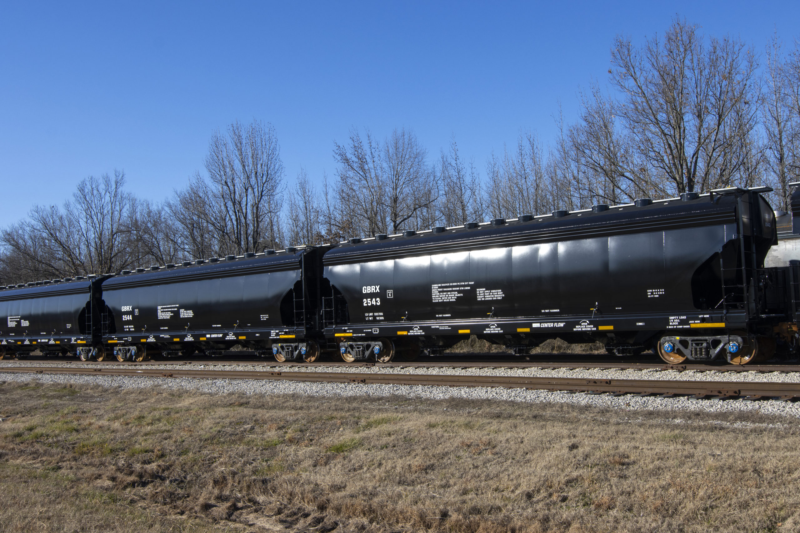 4575 Carbon Back Covered Hopper on tracks.