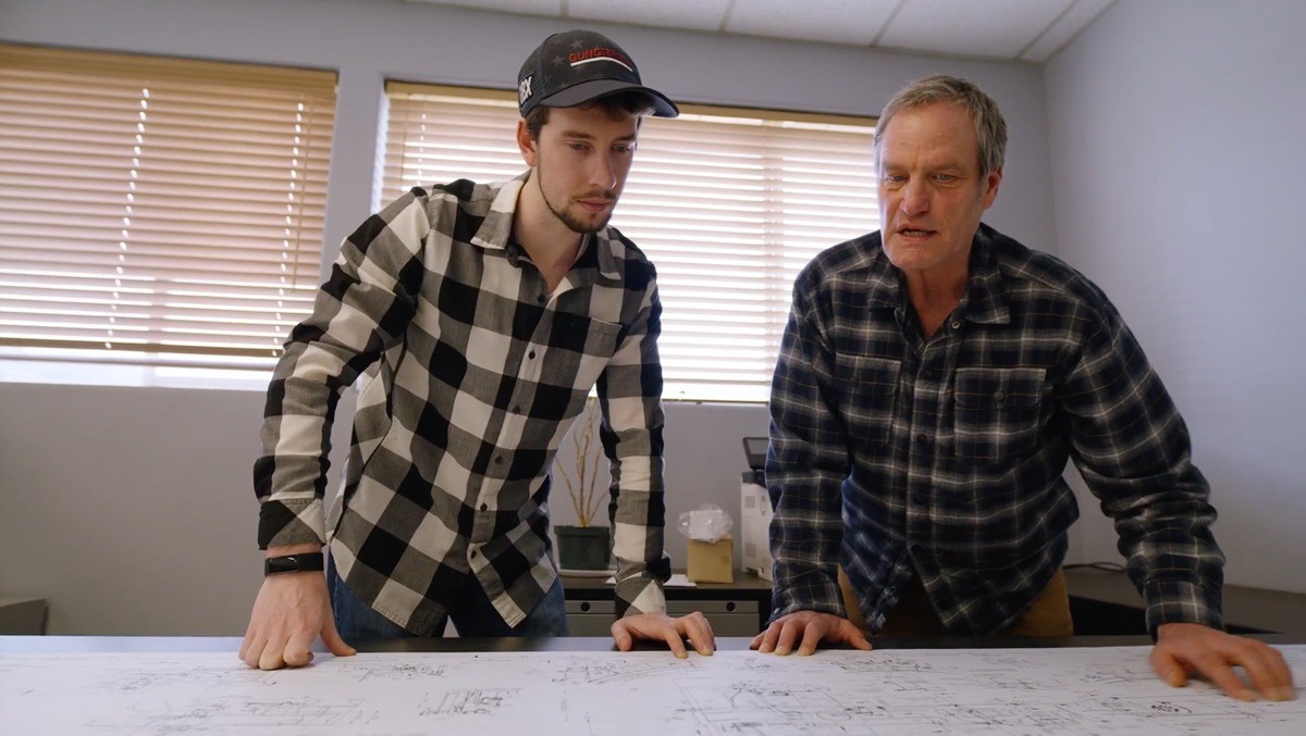 Two team members viewing schematic designs.