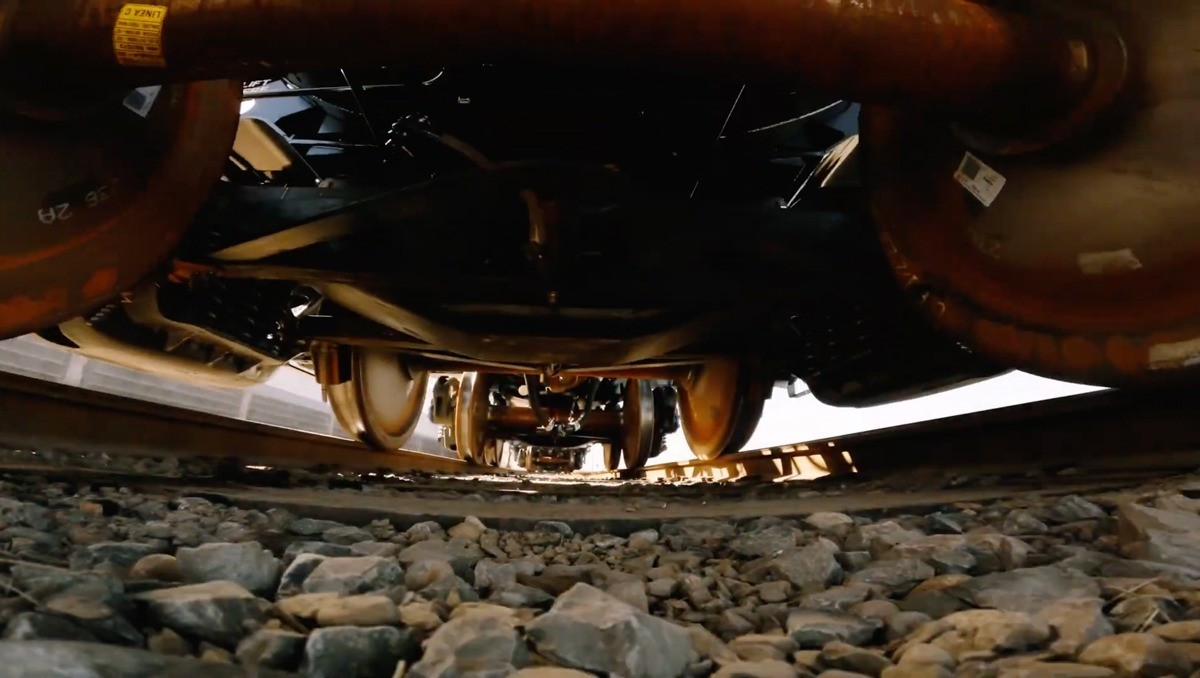 A look under a railcar as it is passing over the tracks.