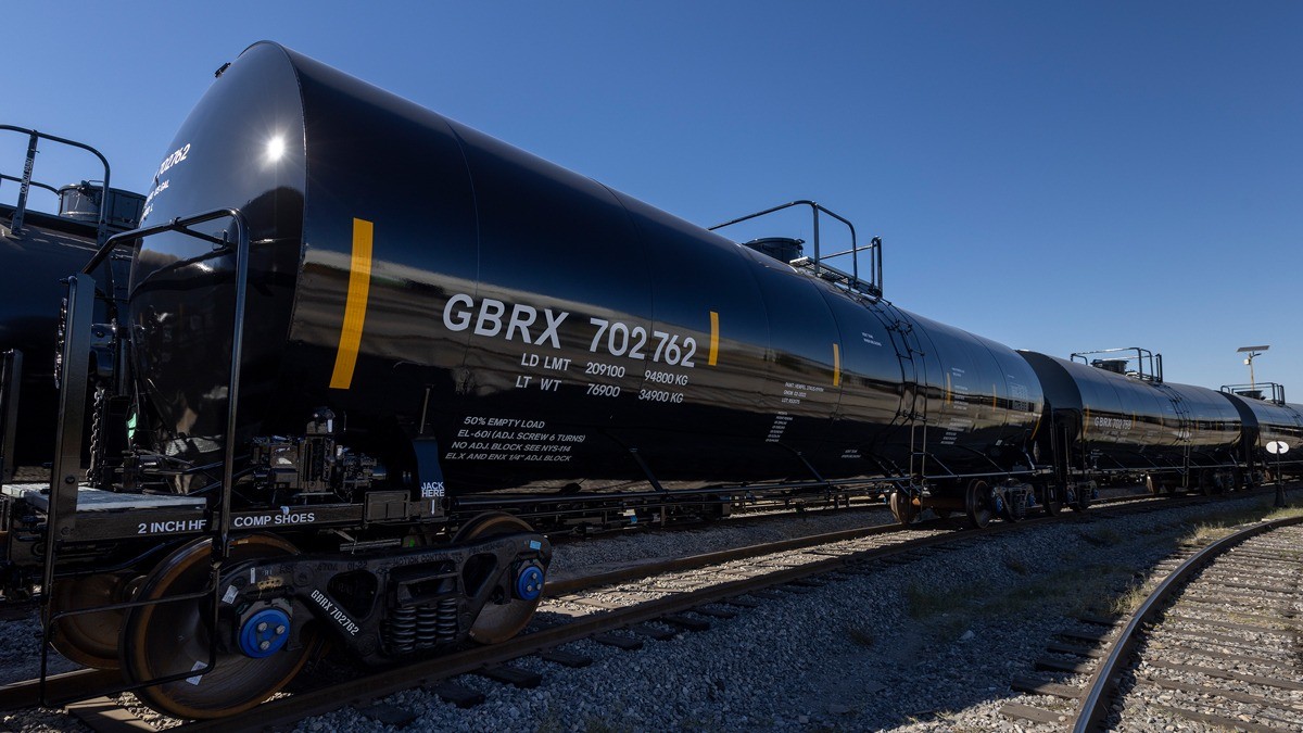 Black GBRX tank car riding on a railroad track