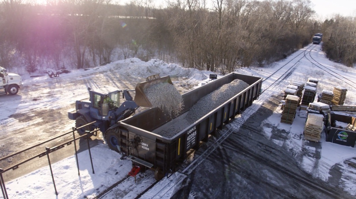 Gravel being loaded into a black GBRX gondola.